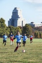 St Louis, Missouri, United States - circa 2016 - Men playing soccer in Forest Park with Chase Park Plaza Hotel