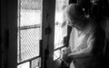 St Louis, Missouri, United States-circa 2007-Old Man Barber Looking at His Watch Checking Time in Vintage Neighborhood Barbershop