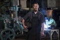 St Louis, Missouri, USA-circa 2015-Portrait of male welder with mask in manufacturing plant and man weld Royalty Free Stock Photo