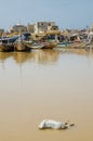 St Louis, Senegal - October 12, 2014: Colorful painted wooden fishing boats or pirogues and dead goat during Tabaski