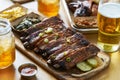 St louis style bbq ribs on table top with sweet tea, beer, collard greens and mac & cheese Royalty Free Stock Photo
