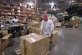 A worker packing a box in a warehouse