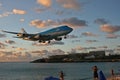 St Maarten, Caribbean, Maho Bay airport Boeing 747 KLM arriving out of the sunset from over the ocean Royalty Free Stock Photo