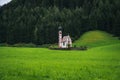 St Magdalena church in Val di Funes valley, Dolomites, Italy. Furchetta and Sass Rigais mountain peaks in background Royalty Free Stock Photo