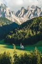 St Magdalena church in Val di Funes valley, Dolomites, Italy. Furchetta and Sass Rigais mountain peaks in background Royalty Free Stock Photo