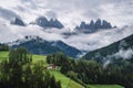 St Magdalena church in Val di Funes valley, Dolomites, Italy. Furchetta and Sass Rigais mountain peaks in background Royalty Free Stock Photo
