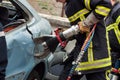 French rescue man with pneumatic machine on crashed car