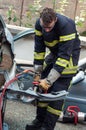 French rescue man with pneumatic machine on crashed car