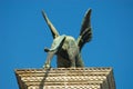 Tail of the Winged Lion, symbol of the city at the high column with the blue sky at the background at San Marco square in Venice. Royalty Free Stock Photo
