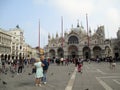 St. Mark`s Square - In the background Clock tower - St. Mark`s Basilica - Stalls selling street vendors Venice Italy