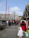 St. Mark`s Square - In the background Clock tower - St. Mark`s Basilica - Stalls selling street vendors Venice Italy
