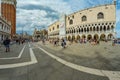 St. Mark Square, VENICE, ITALY - August 02, 2019: Torre dell Orologio, Basilica and Museum San Marco Locals and tourists strolling Royalty Free Stock Photo