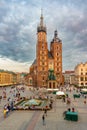 St. Mary gothic church in the Market square of Krakow, Poland at sunset with stormy clouds. Aerial view Royalty Free Stock Photo