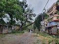 21st May 2020 - Narendrapur, West Bengal, India. Trees destroyed and fallen on road as pedestrians walk by as an aftermath of