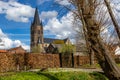 St. Michael\'s Abbey Church with its bell tower against blue sky with white clouds Royalty Free Stock Photo