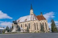 St. Michael`s Church and Matthias Corvinus Monument in the city center of Cluj-Napoca, Romania during a sunny day with blue sky Royalty Free Stock Photo