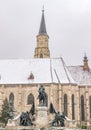 St. Michael& x27;s Church and Matthias Corvinus Monument during winter in the city center of Cluj-Napoca, Romania Royalty Free Stock Photo