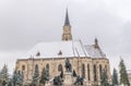 St. Michael& x27;s Church and Matthias Corvinus Monument during winter in the city center of Cluj-Napoca, Romania Royalty Free Stock Photo