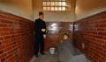 Victorian prison cell with prisoner and police mannequins. Royalty Free Stock Photo