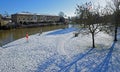 St Neots river park in the snow trees and riverside houses in the sunshine