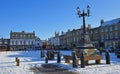 St Neots town square covered in snow with blue sky.