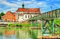 St. Oswald Church with Eiserner Steg bridge across the Danube River in Regensburg, Germany Royalty Free Stock Photo