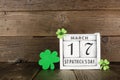 St Patrick Day on a rustic shabby chic calendar with shamrocks against dark wood