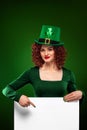 St Patrick Day. Young oktoberfest woman, wearing a dress and green hat with white banner for copy space Royalty Free Stock Photo