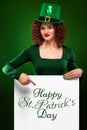 St Patrick Day. Young oktoberfest woman, wearing a dress and green hat with white banner for copy space Royalty Free Stock Photo