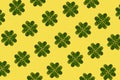 St Patrick holiday concept background. Pattern created of minimal lucky shamrock arranged from hearts formed of fresh green leaves