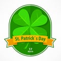 St Patrick label with lucky shamrock and ribbon on white