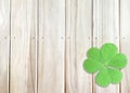 St. Patrick`s Day Background with Green Shamrocks on Wooden Texture