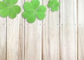 St. Patrick`s Day Background with Green Shamrocks on Wooden Texture