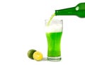 St. Patrick`s Day from a bottle in a beer glass pours a traditional green Irish beer with thick foam on an isolated background