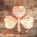 St. Patrick`s Day. Bright trace three-sheeted clover on a wooden surface Royalty Free Stock Photo