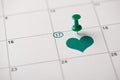 St. patrick`s day is coming concept. Cropped close up view photo picture of pushpin attached to the calendar with green heart