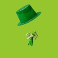 St. Patrick`s Day concept. Irish glittery hat, and bow with shamrock leaf clovers in gold and green colors, and curly ribbon In o