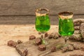 St. Patrick`s Day concept. Traditional green cocktail, sweet chocolate in the shape of clover leaves Royalty Free Stock Photo