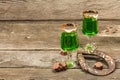 St. Patrick`s Day concept. Traditional green cocktail, sweet chocolate in the shape of clover leaves Royalty Free Stock Photo