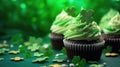 St. Patrick's Day cupcake with whipped cream decorated clover on green background.