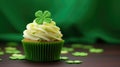 St. Patrick's Day cupcake with whipped cream decorated clover on green background.