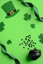 St Patrick`s Day flat lay composition. Saint Patricks Day green background with leprechaun hat, shamrock leaves, pot of gold,