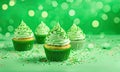 St Patrick\'s day, food and holidays concept. Close up of green cupcakes and bokeh