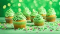 St Patrick\'s day, food and holidays concept. Close up of green cupcakes and bokeh