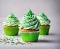 St Patrick\'s day, food and holidays concept. Close up of green cupcakes and bokeh