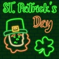 St. Patrick`s Day glowing neon sign. Neon leprechaun with hat and shamrock on a dark green brick wall. Royalty Free Stock Photo