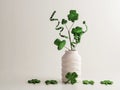 St. PatrickÃ¢â¬â¢s Day green glitter shamrock, four leaf clover, hat and swirls in a white vase with more four leaf clovers lined up