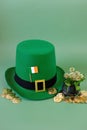 St.Patrick 's Day. leprechaun hat, flag of Ireland, bowler hat with gold coins, bunch of clovers on a green background