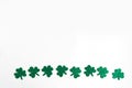 St. Patrick`s Day lower border paper shamrocks on white background. Royalty Free Stock Photo