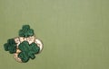 St. Patrick`s Day Luck Themed Flat Lay with Gold Coins and Green Shamrocks on Light Green Background